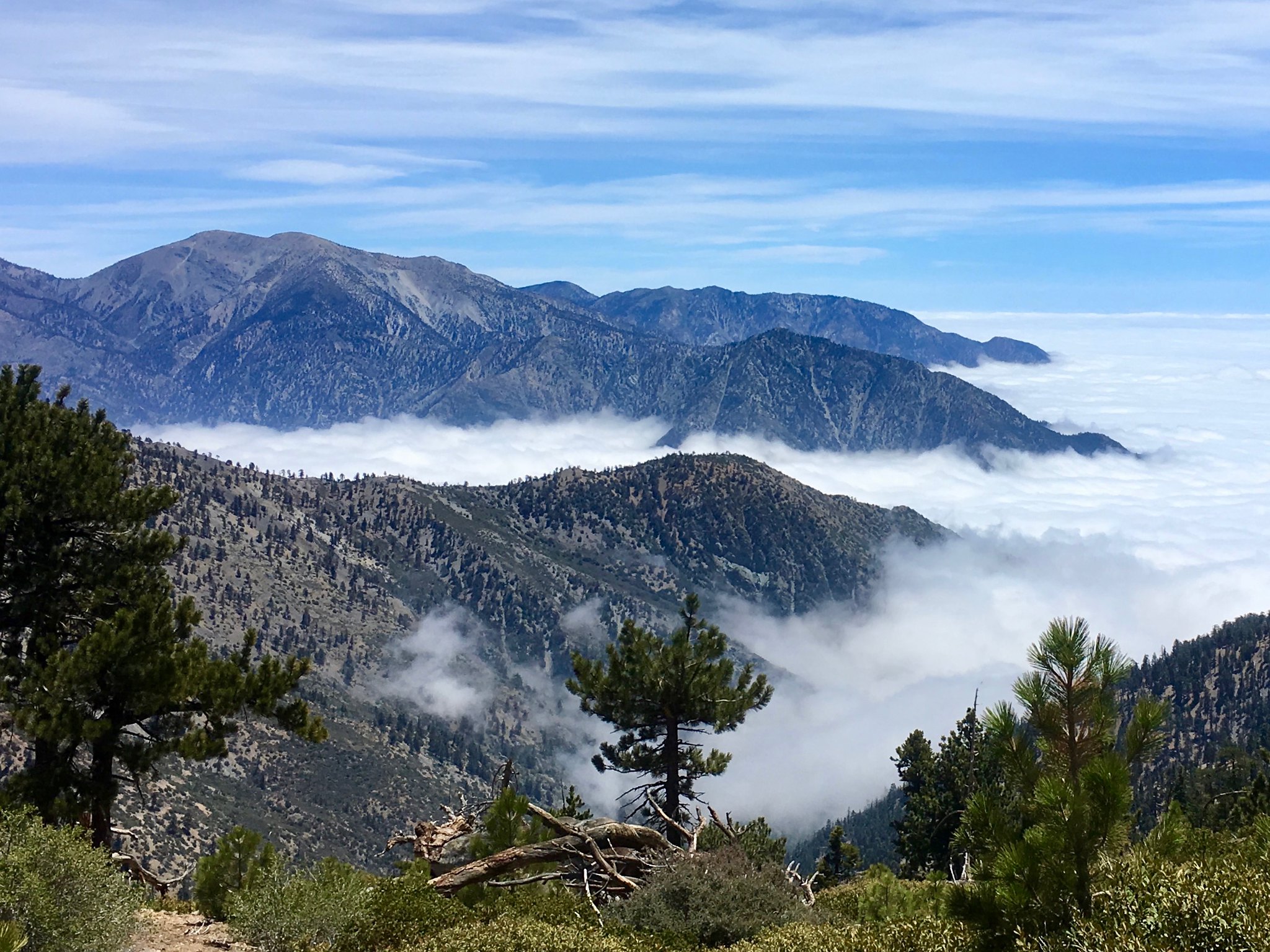 clouds filling valleys between mountain peaks